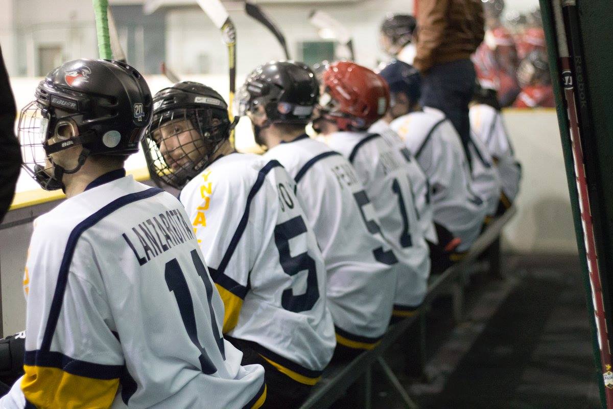 Row of hockey players sitting on bench