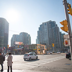 Toronto Cityscape showing a few highrise buildings, in front of which is a busy intersection