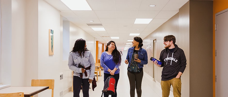 4 students walking in the hallway