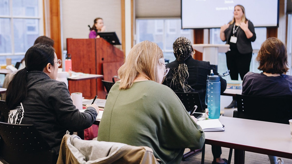 A classroom of students listening to the lecturer. 