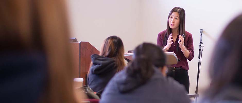 Dr. Helen Noh teaching in front of group of students