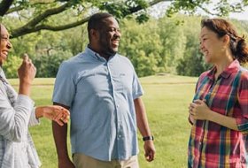Three students conversing outdoors