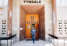Student walking out of Tyndale main entrance
