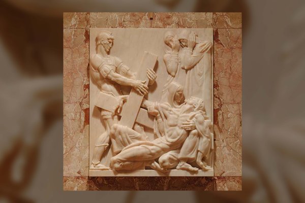 Rose marble sculptor of Jesus being nailed to the cross