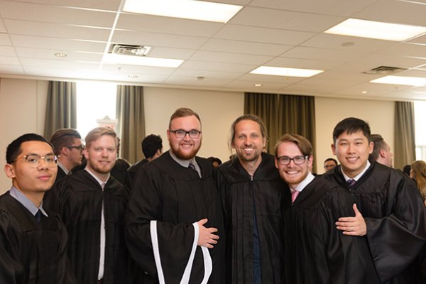 A group of UC Grads in their robes before the ceremonies
