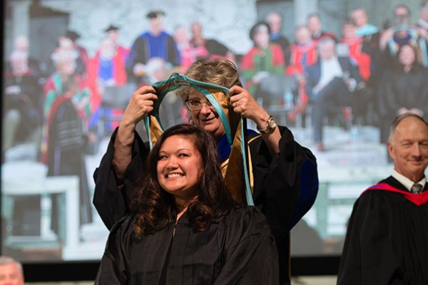 Graduate receiving the convocation hood
