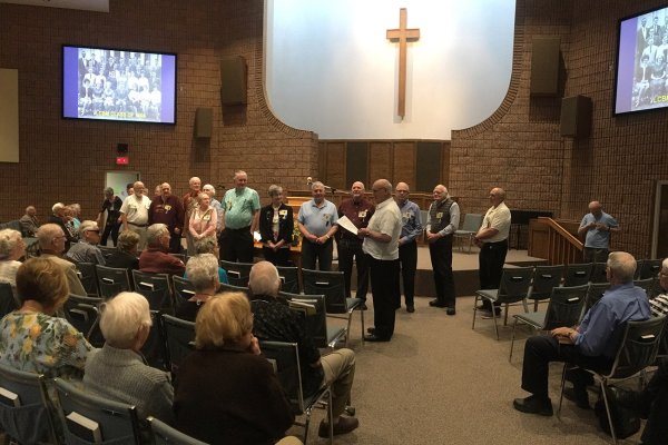 Photo of Golden Milers being honoured at front of church
