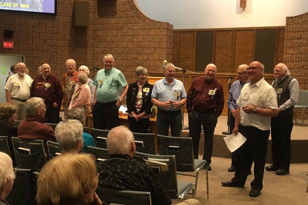 Photo of Golden Milers being honoured at front of church, closer angle