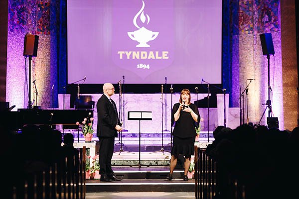 Kevin Kirk with a student on stage