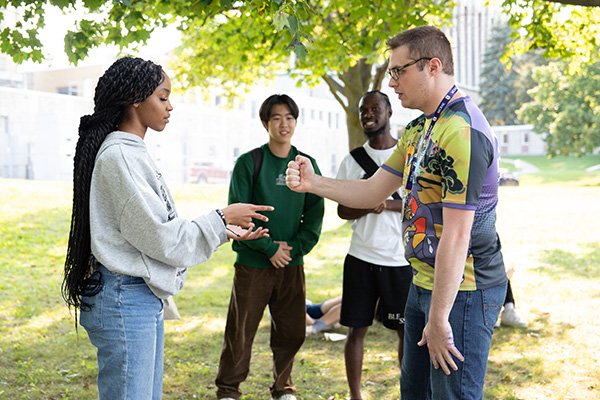 Students competing in a rock, paper, scissors tournament