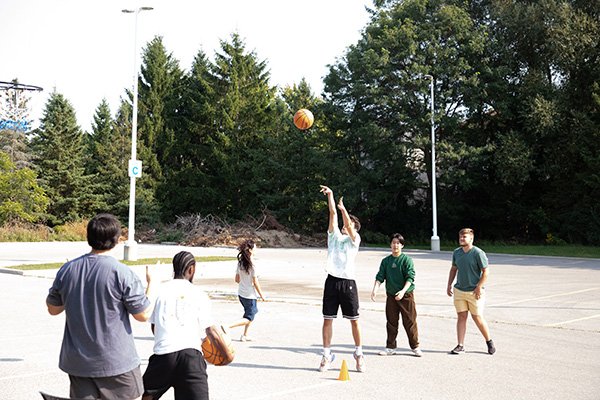 Students playing outdoor basketball