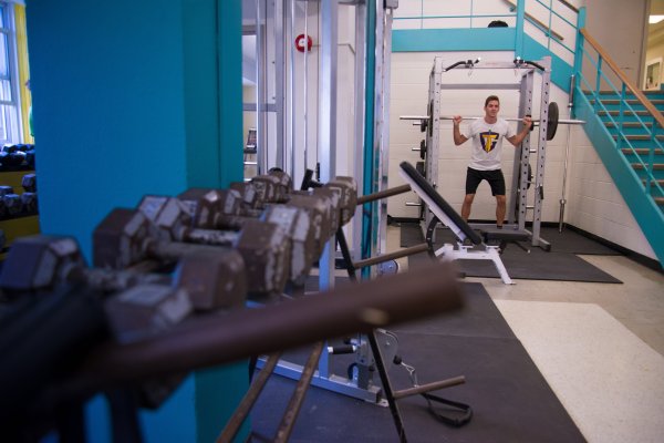 Fitness Centre with man lifting weights