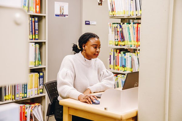 Student studying at an individual study carrel