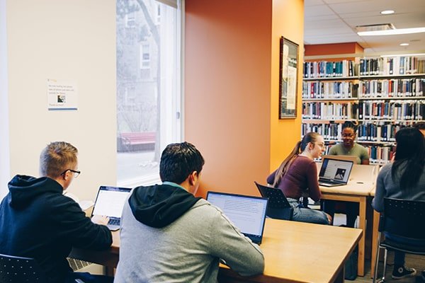 Students studying at group tables