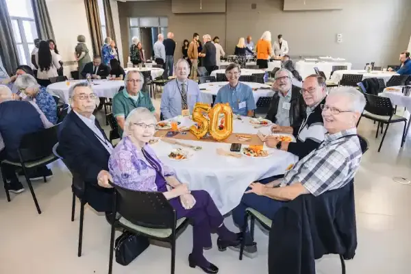 Homecoming alumni sitting around table