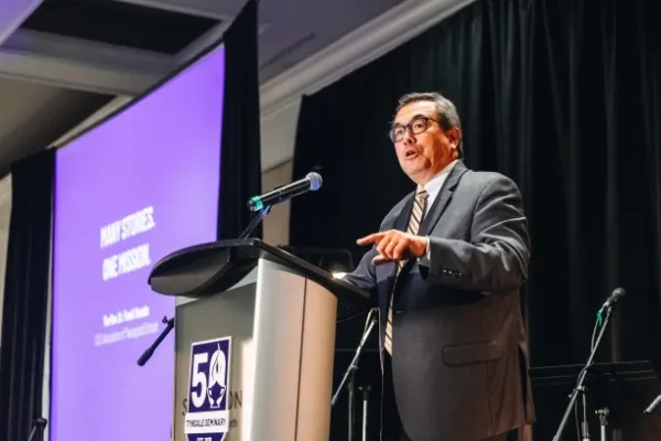 Dr. Frank M. Yamada speaking at podium
