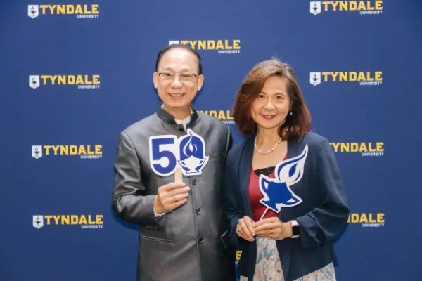 Alumni holding Tyndale Seminary 50th signs