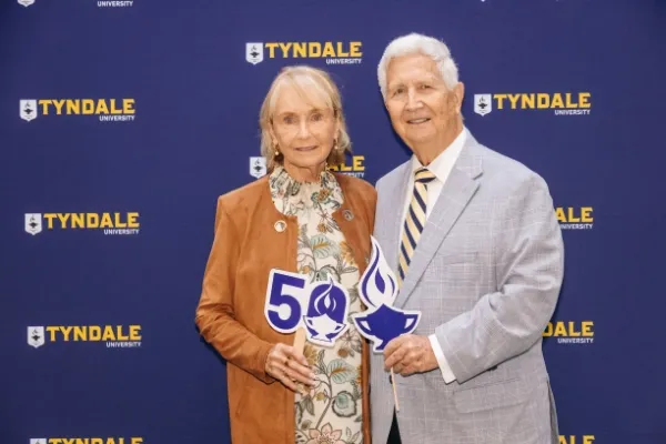 Alumni holding Tyndale Seminary 50th signs